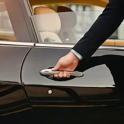 Ein Chauffeur öffnet eine Autotür